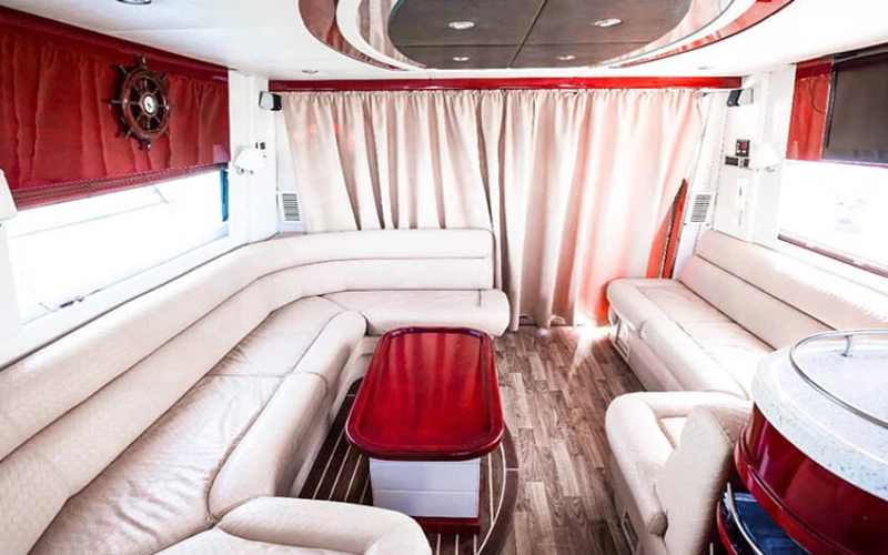 Elegant salon on Riva Yacht 50 featuring modern Italian design, cream leather sofas, ambient LED lighting, and panoramic windows