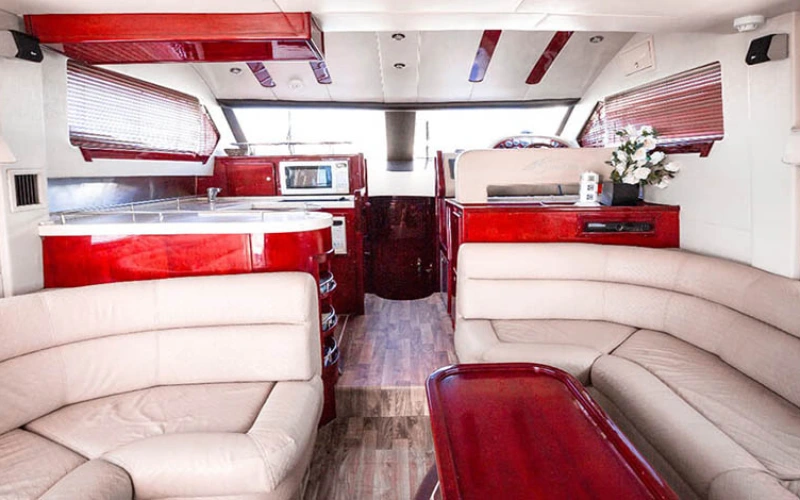 Plush sofa seating on the deck of a luxury yacht – perfect for relaxing during your yacht rental in Dubai.