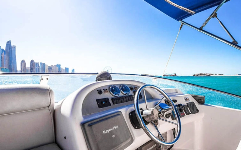 High-tech helm station on Riva Yacht 50 featuring touchscreen navigation panels, leather captain’s chair, and panoramic windshield views