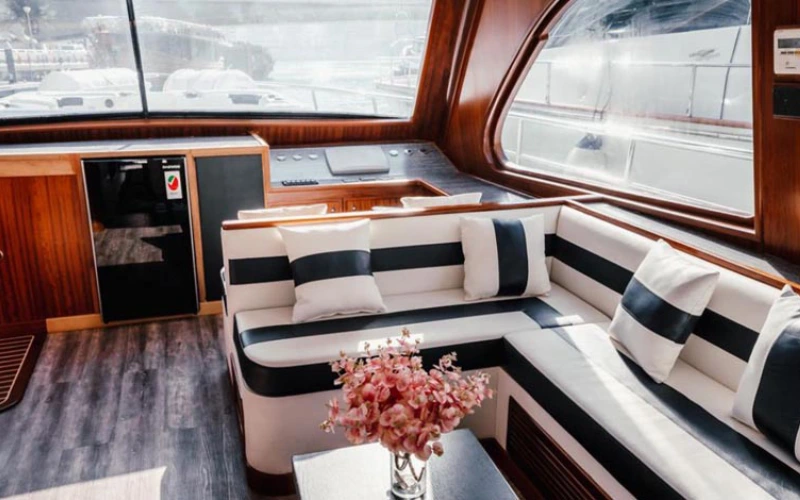 Luxurious indoor lounge area inside Venus Yacht with elegant sofas – available through Mala Yachts yacht rental in Dubai