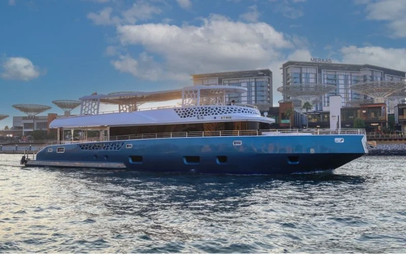 Wide-angle exterior shot of Arabian Pearl Yacht cruising along the coast – explore luxury with Mala Yachts yacht rental in Dubai