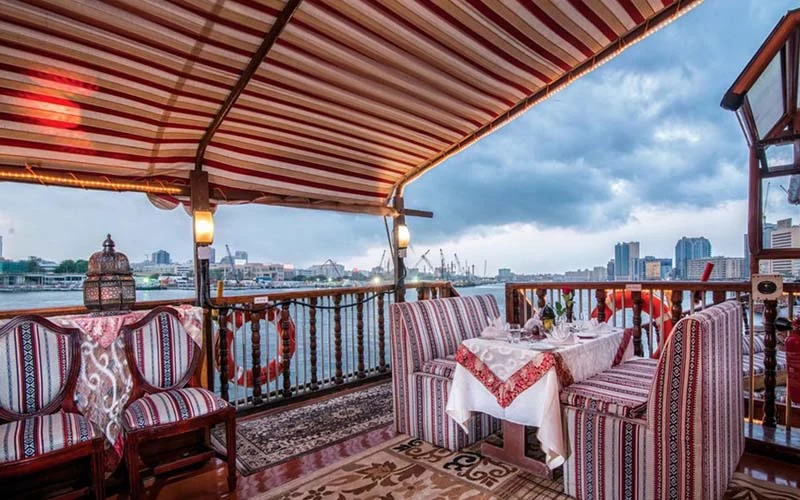 Cozy indoor seating on Al Mansour Yacht designed for dinner cruises – top choice with Mala Yachts yacht rental in Dubai