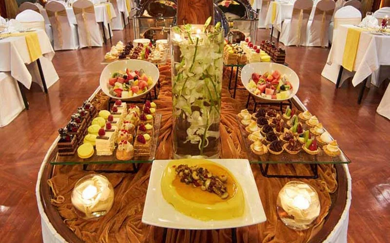 Buffet station setup inside Al Mansour Dinner Yacht for large gatherings – ideal for corporate events via yacht rental in Dubai