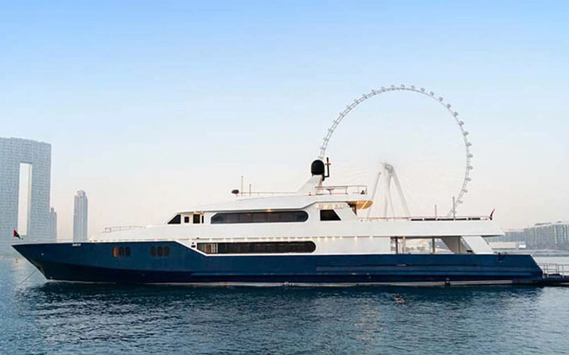 Side view of the grand 141 Feet Yacht cruising along the Dubai coastline – available with Mala Yachts yacht rental in Dubai