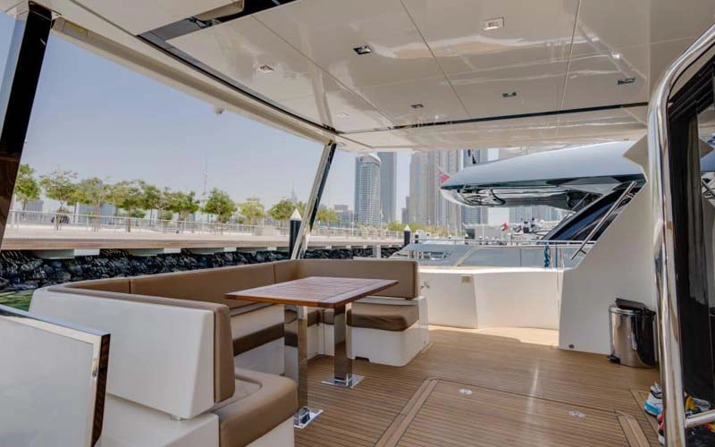 Elegant dining setup on the 78 Feet Yacht with sea views – experience premium service with Mala Yachts yacht rental in Dubai