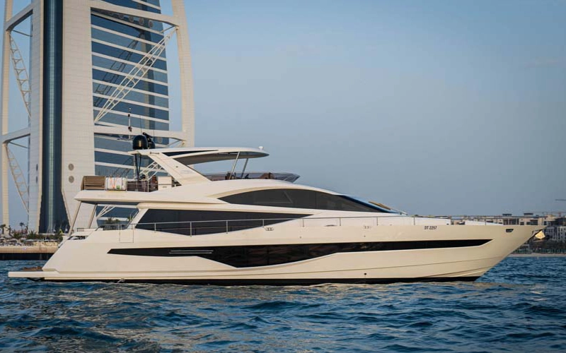 Side view of 78 Feet Yacht cruising in Dubai’s blue waters – available through Mala Yachts yacht rental in Dubai
