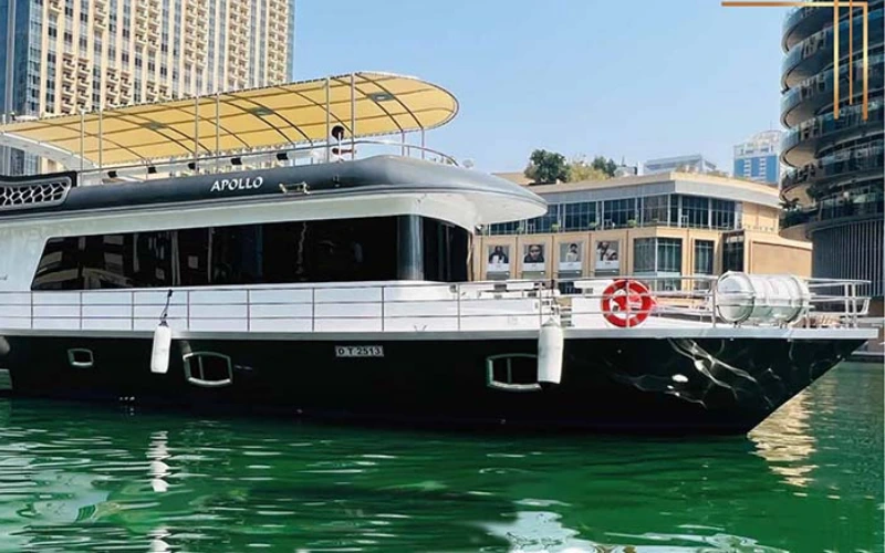 Sleek side view of Apollo 85ft yacht cruising through Dubai Marina – available via Mala Yachts yacht rental in Dubai