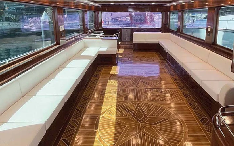 Dining area aboard Apollo 85 Feet Yacht with stylish seating and panoramic windows – book through Mala Yachts for premium yacht rental in Dubai