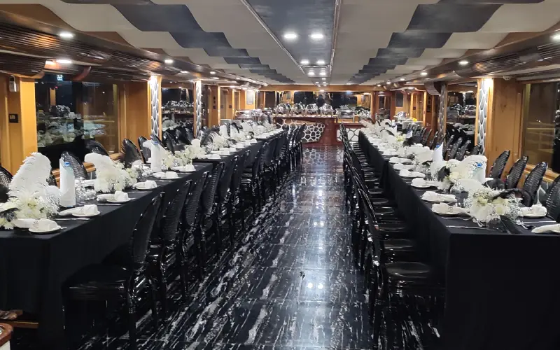 Spacious indoor dining area aboard Desert Rose Yacht ideal for group events – enjoy this with Mala Yachts yacht rental Dubai