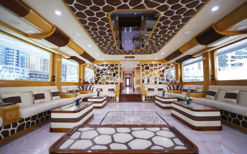 Lavish lounge on Desert Rose Yacht with plush seating and elegant lighting – offered by Mala Yachts yacht rental in Dubai