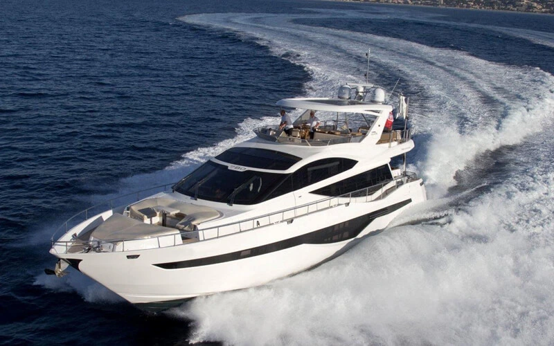 Side view of Galeon Yacht cruising through clear waters with a sleek, modern design