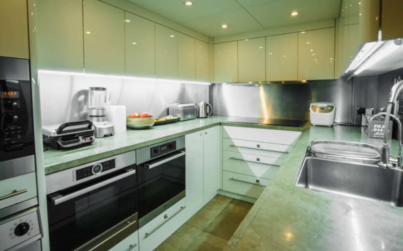 Modern kitchen area inside Lucien 131 yacht featuring premium appliances and sleek countertops – available through Mala Yachts’ luxury yacht rental in Dubai