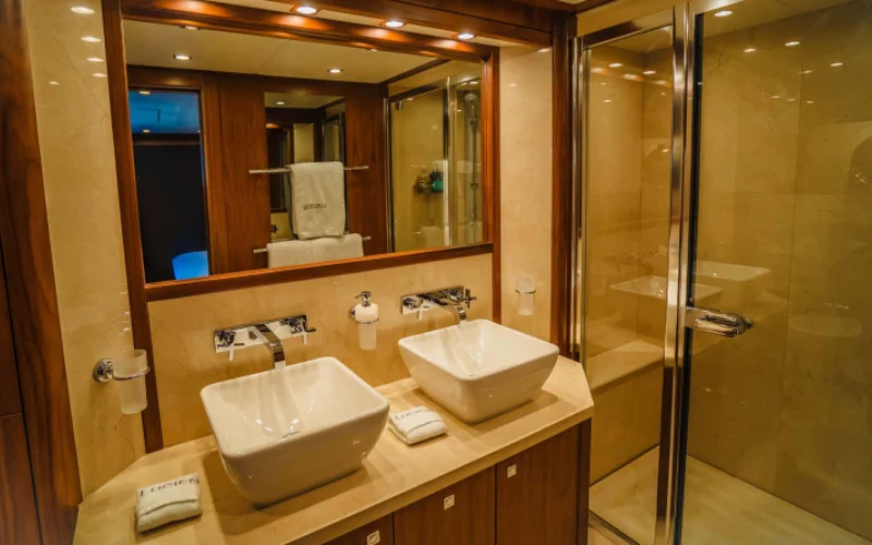 Spacious bathroom on Lucien 131 yacht with elegant fittings and marine-inspired design – part of the high-end experience from Mala Yachts’ yacht rental Dubai