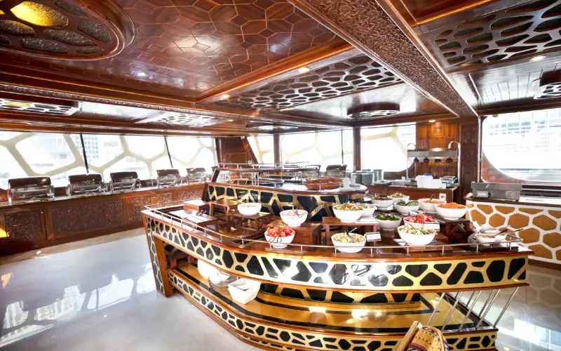 Luxurious indoor dining hall on Ocean Empress with ambient lighting and sea-facing windows
