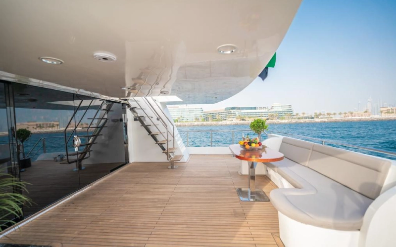 Spacious main salon on 151ft Yacht with luxury furnishings, ambient lighting, and panoramic windows