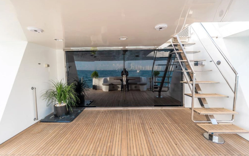 Upper outdoor area on 151ft Yacht featuring sunbeds, shaded seating, and a relaxing ambiance