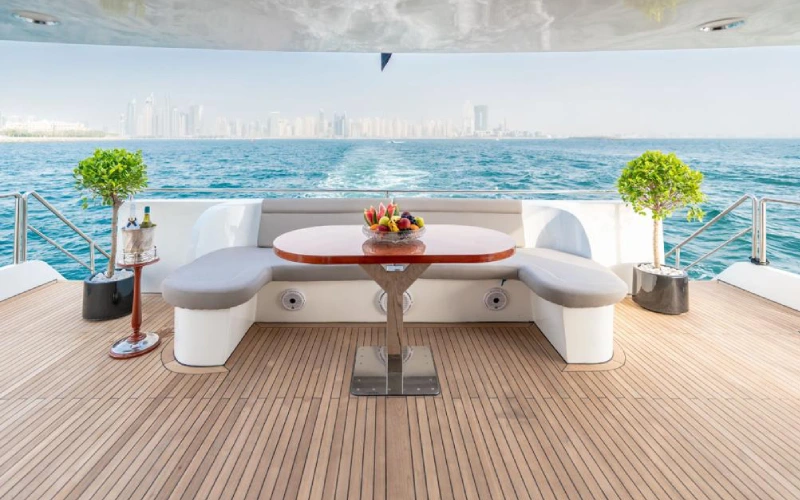 Elegant dining space on 151ft Yacht with panoramic windows and a formal setup for fine dining at sea