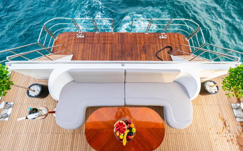 Outdoor dining table on 151ft Yacht’s upper deck with sea view and stylish setup