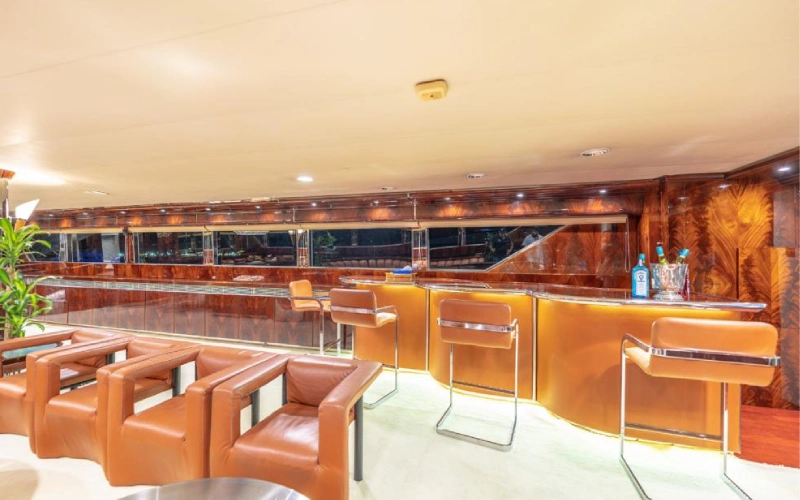 Luxurious indoor dining room on 151ft Yacht featuring a long polished table, designer chairs, and ambient lighting
