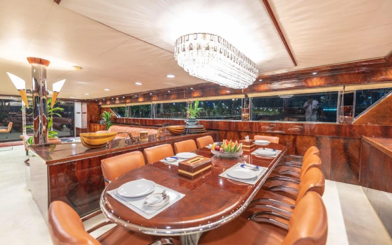 Elegant dining room on 151ft Yacht with a large formal table and upscale interior décor