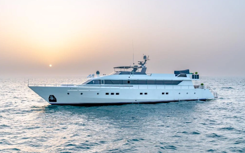 Aerial view of 151ft Yacht cruising through turquoise waters with luxury outdoor decks