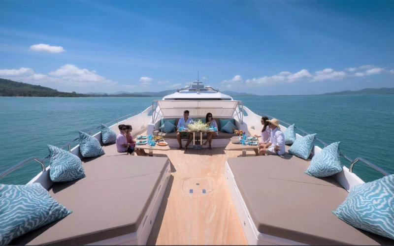 Top deck of Dolce Vita Yacht with sunbeds and a shaded relaxation area