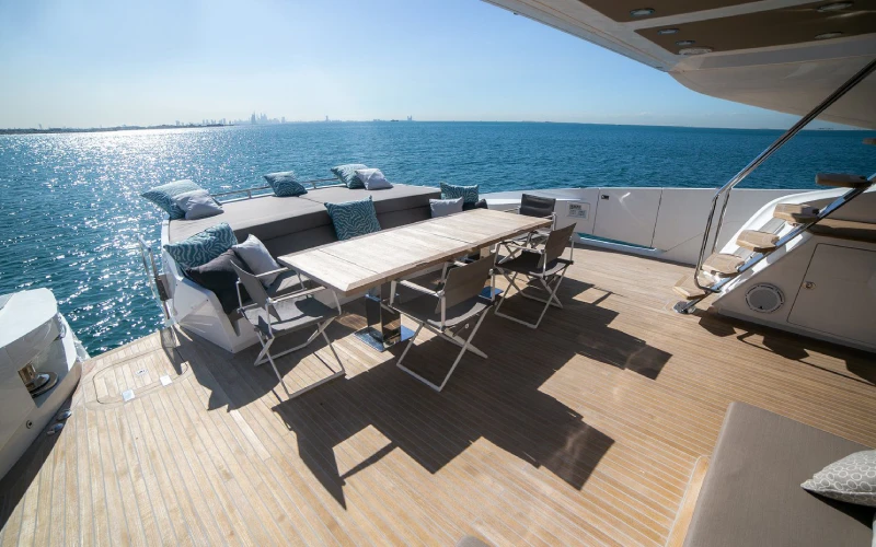 Modern dining area aboard Dolce Vita Yacht with a glass table and panoramic sea views