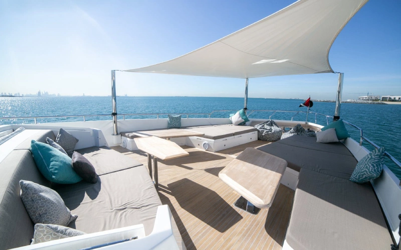 Spacious outdoor deck on Dolce Vita Yacht with cushioned seating and panoramic ocean views