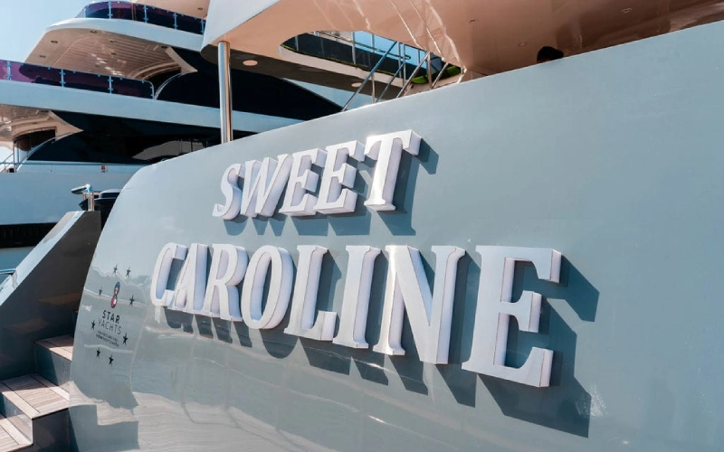 "Sweet Caroline Yacht cruising on open water with a luxurious white exterior and elegant deck design"