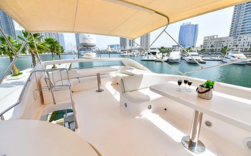 Top deck of Silver Queen Yacht with sun loungers and clear blue sky in the background