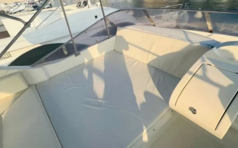 Elegant indoor lounge on Majesty 77ft Yacht with plush sofas and large panoramic windows