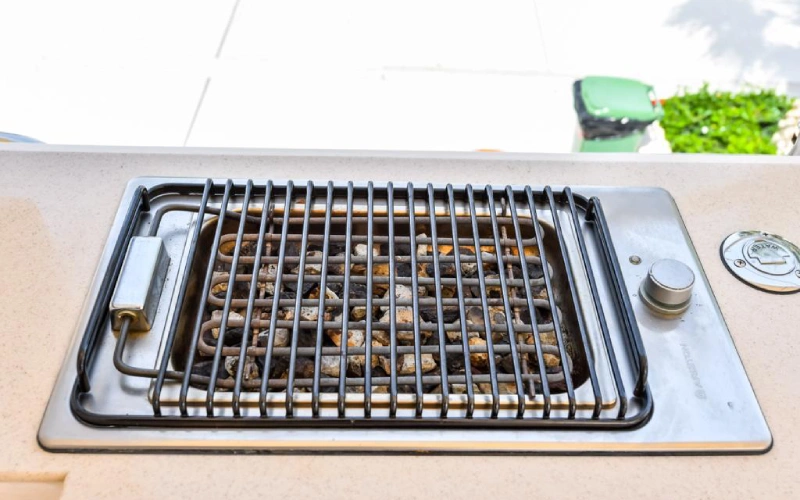 Outdoor grill BBQ setup on Silver Queen Yacht with stainless steel equipment and ocean backdrop