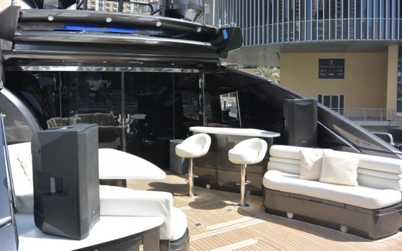 Spacious outdoor lounge on Black Beauty Yacht with cushioned seating and ocean views