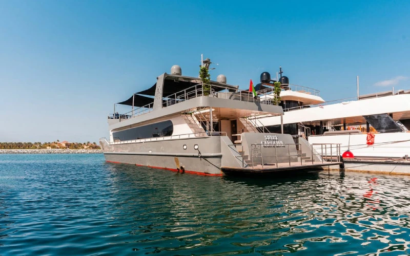 Side profile of Sweet Caroline Yacht cruising through open waters with a sleek white exterior