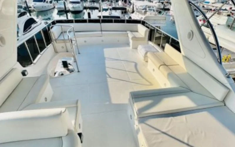 Open-air deck on Majesty 77ft Yacht with cushioned seating and panoramic ocean views