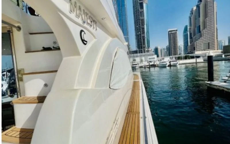 Side view of Majesty 77ft Yacht cruising across open water with a sleek white profile