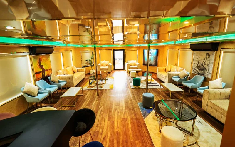 Luxurious indoor lounge on Playboy 90ft Yacht with designer sofas and ambient lighting