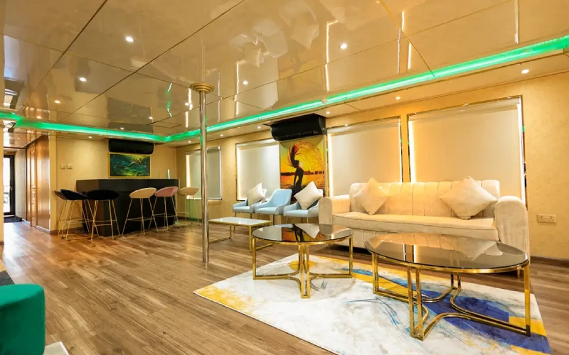 Stylish dining and lounge area inside Playboy 90ft Yacht featuring ambient lighting and elegant décor