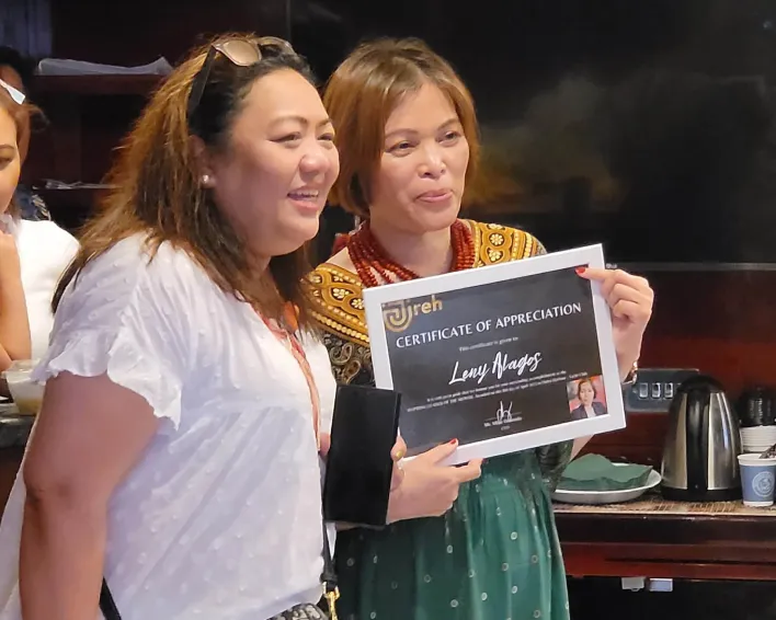 "Winners posing with certificates and awards after a formal recognition event."