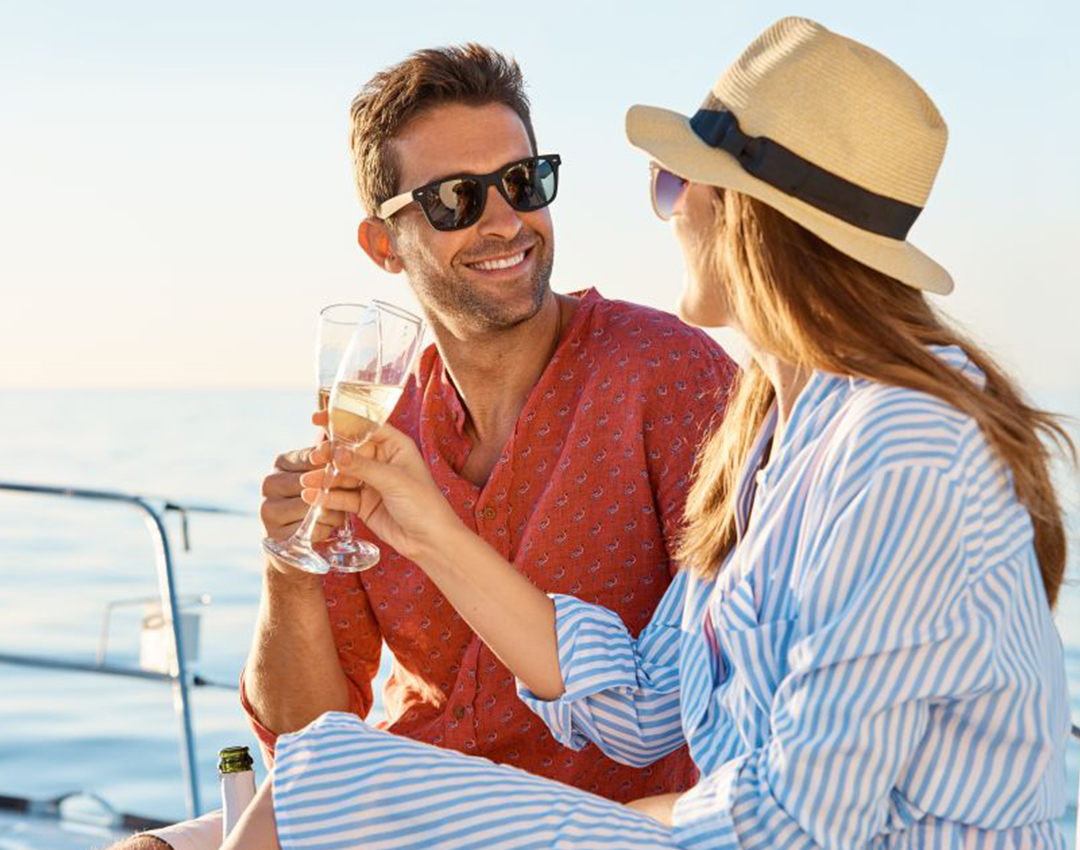 Couple enjoying champagne on luxury yacht rental Abu Dhabi with Mala Yachts