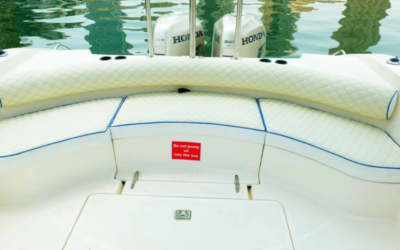 Modern indoor lounge on Blue Fin Yacht featuring cushioned sofas and ambient lighting