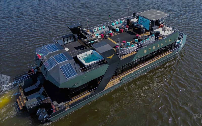 Top deck of Stealth Yacht featuring sunbathing lounge area with panoramic ocean views