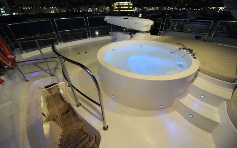 Luxurious Jacuzzi on the upper deck of Lady of the Sea yacht with ocean view backdrop