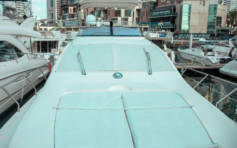 Front deck of 36ft yacht with sunbathing cushions and stainless railings
