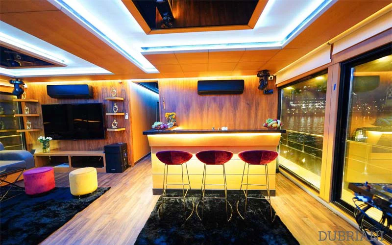 Futuristic lounge inside Stealth Yacht with sleek black seating and ambient lighting