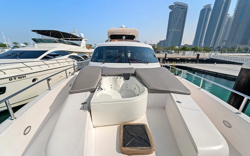 Expansive upper deck on Big Daddy Yacht with open-air seating, sun loungers, and panoramic views of Dubai’s coastline