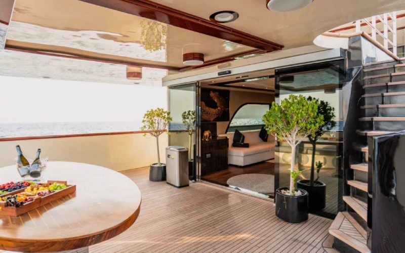 Modern indoor lounge on AK Yacht with cushioned seating and ambient lighting