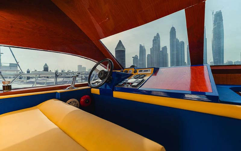 Captain’s cockpit aboard Sasmi 48ft Yacht with control panel and panoramic windshield