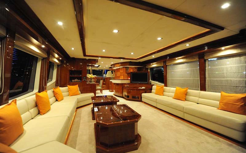 Elegant salon inside Lady of the Sea yacht with plush seating and warm lighting