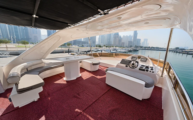 Elegant salon aboard Big Daddy Yacht with plush leather seating, air-conditioned lounge area, TV‑stereo system and ambient lighting